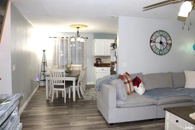 a view of a dining room with furniture and chandelier