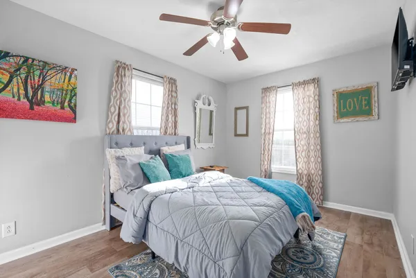 a bedroom with a bed a dresser and a window