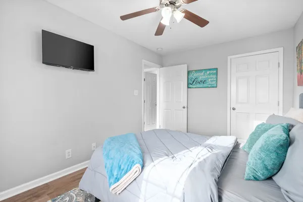 a bedroom with a bed and a flat screen tv