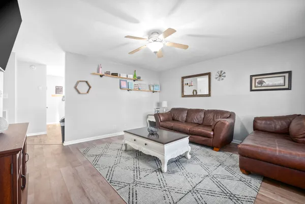 a living room with furniture and a wooden floor