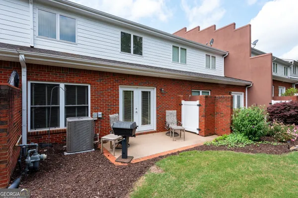 a view of a house with backyard sitting area and garden
