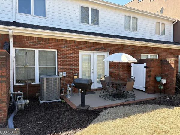 a front view of a house with outdoor seating
