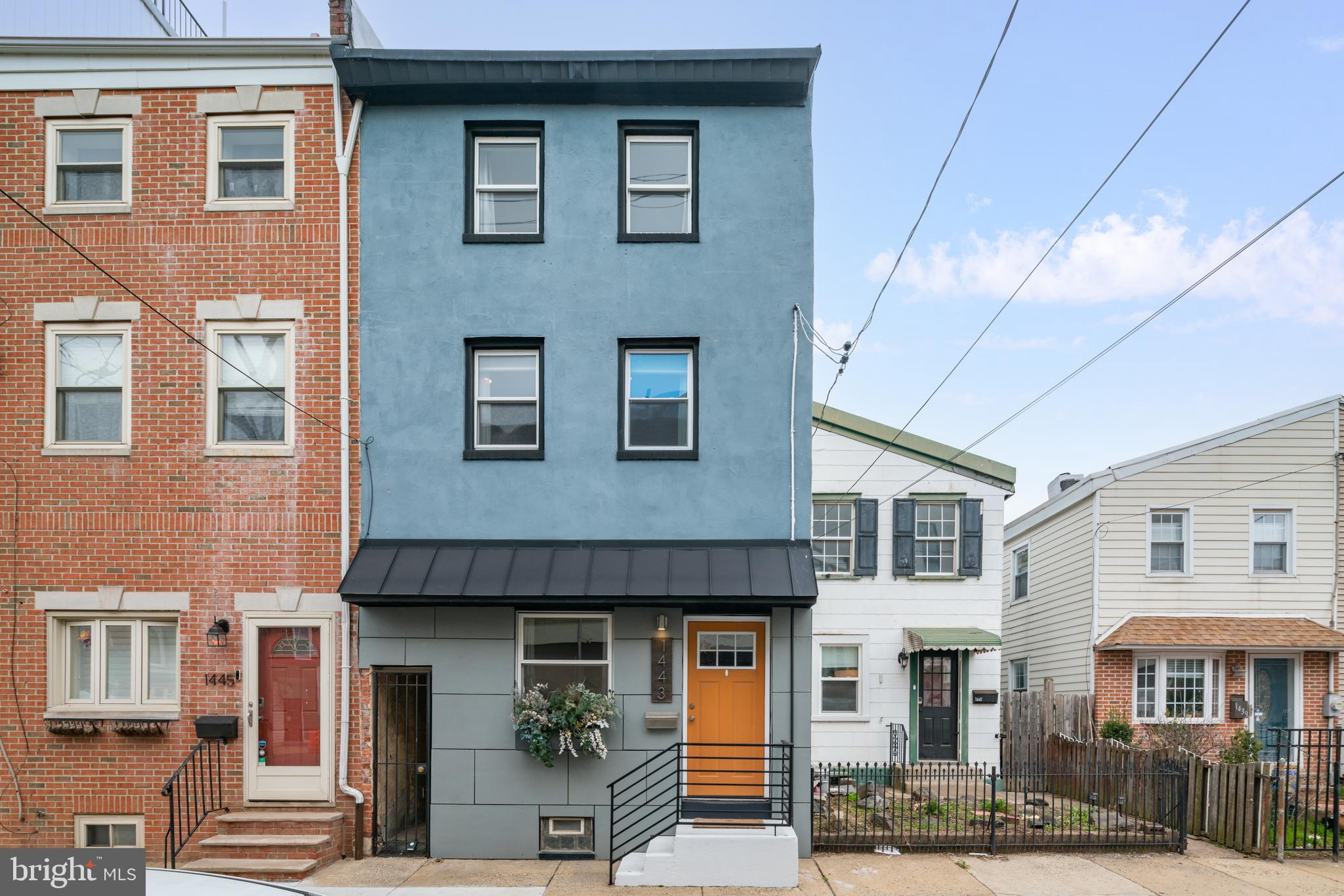 1443 East Oxford Street Philadelphia, PA 19125 - Photo 27 of 28 a front view of a brick house with many windows