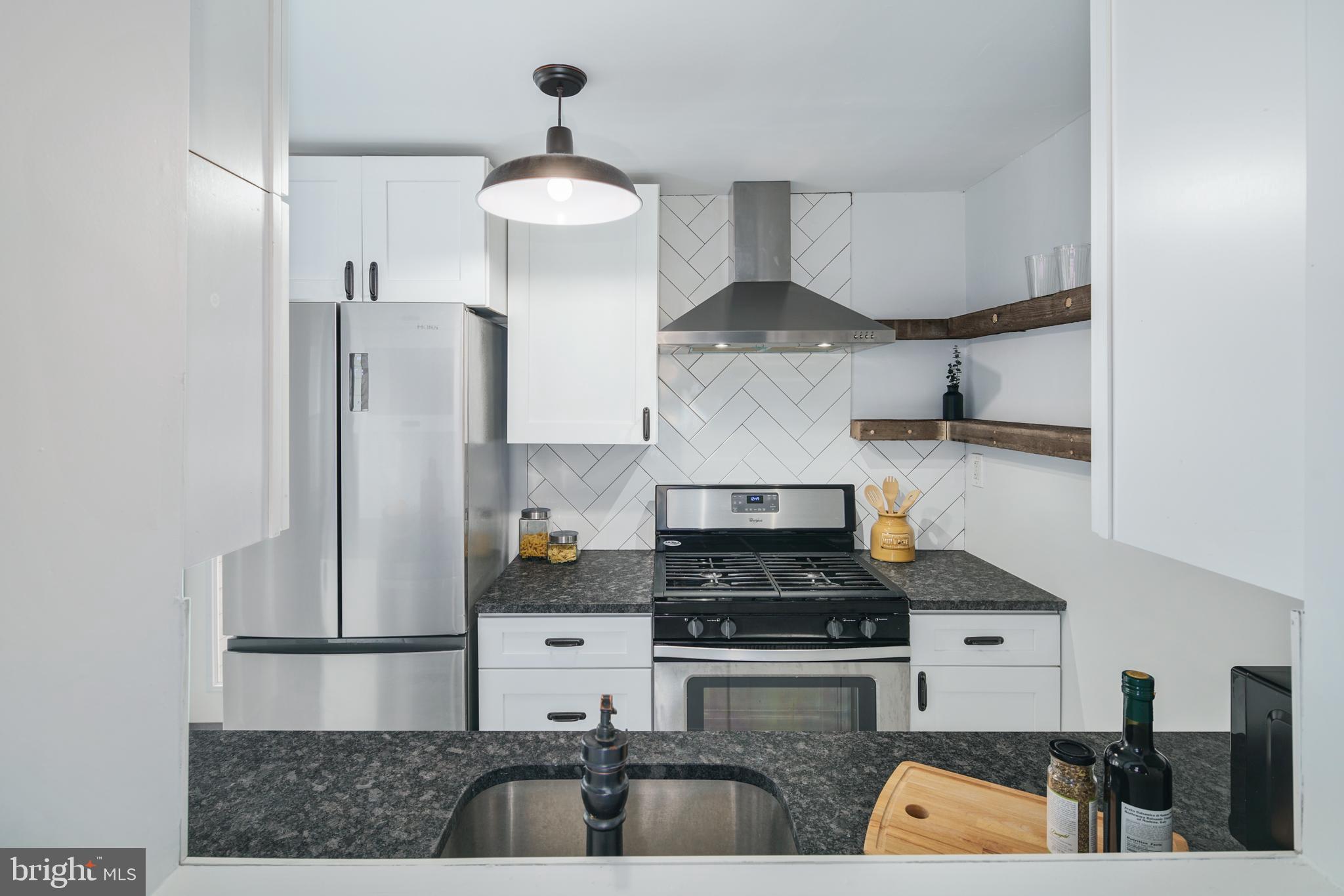1443 East Oxford Street Philadelphia, PA 19125 - Photo 6 of 28 a kitchen with stainless steel appliances granite countertop a sink and a stove