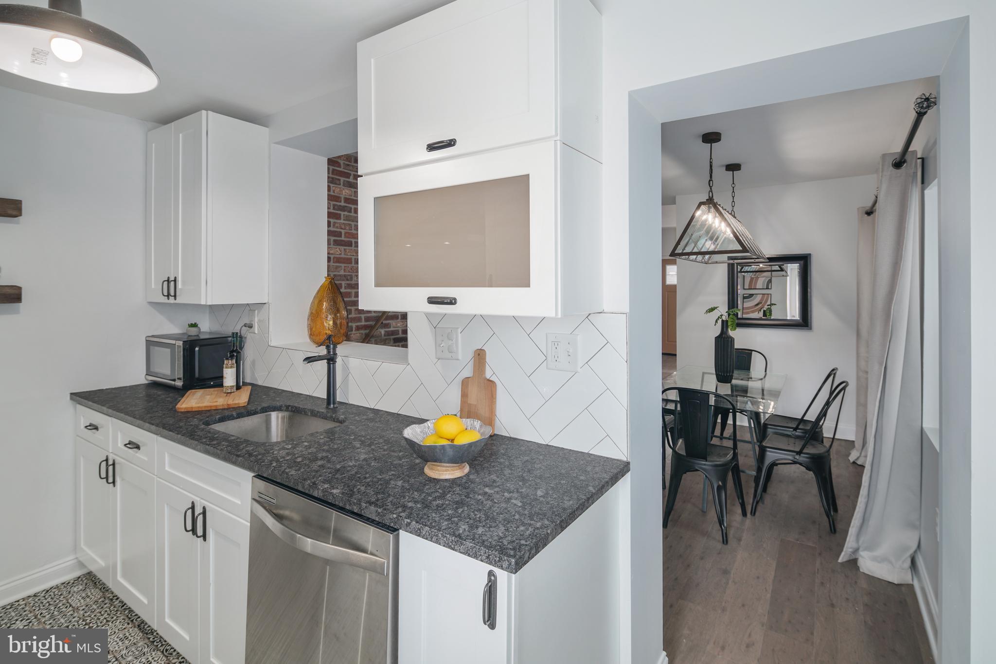 1443 East Oxford Street Philadelphia, PA 19125 - Photo 7 of 28 a kitchen with a sink a table and chairs in it
