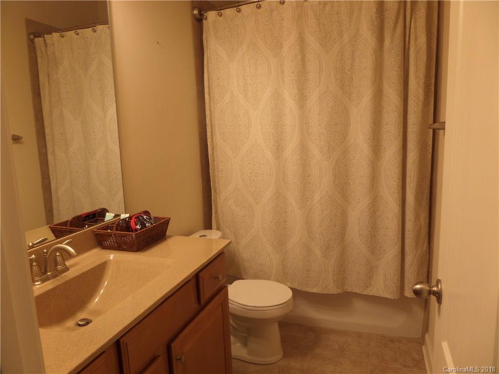 1434 Cilantro Court Tega Cay, SC 29708 - Photo 14 of 27 a bathroom with a sink a toilet and shower curtain