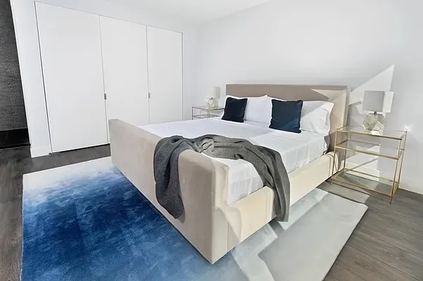 a bed room with a bed and a night stand