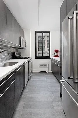 a kitchen with stainless steel appliances granite countertop a refrigerator and a stove