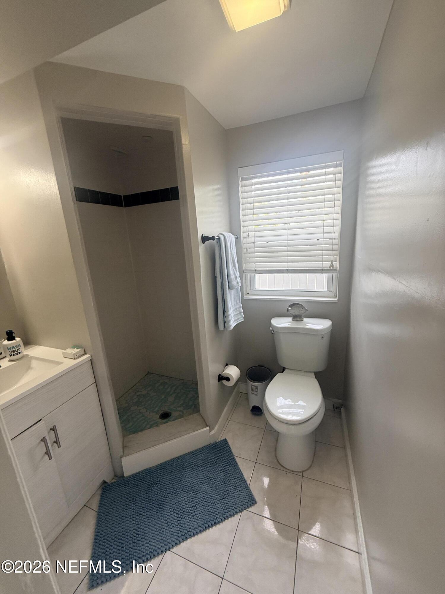 200 Walnut Street, Unit 1 Neptune Beach, FL 32266 - Photo 11 of 12 a white toilet sitting next to a bathroom sink