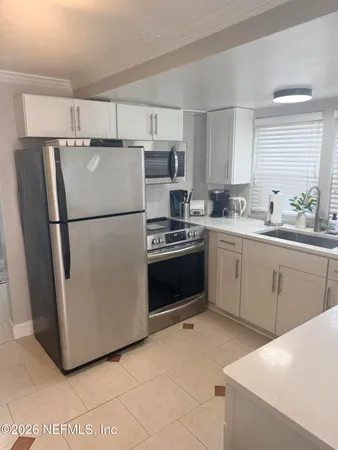 a kitchen with a refrigerator sink and stove