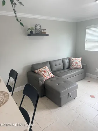 a living room with furniture and painting on the wall