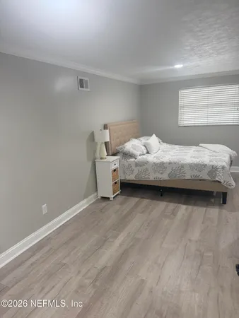 a bedroom with a bed and window