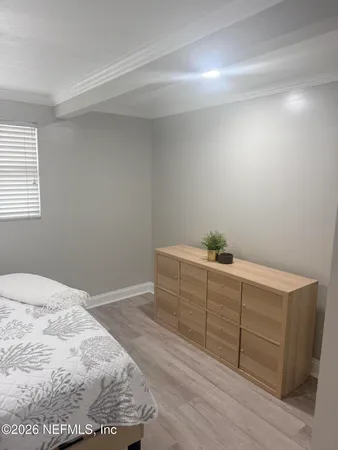 a room with a dresser and a window