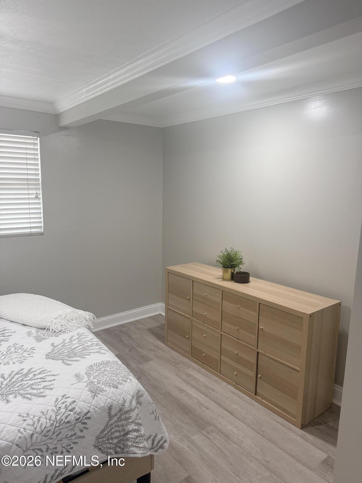 200 Walnut Street, Unit 1 Neptune Beach, FL 32266 - Photo 7 of 12 a room with a dresser and a window