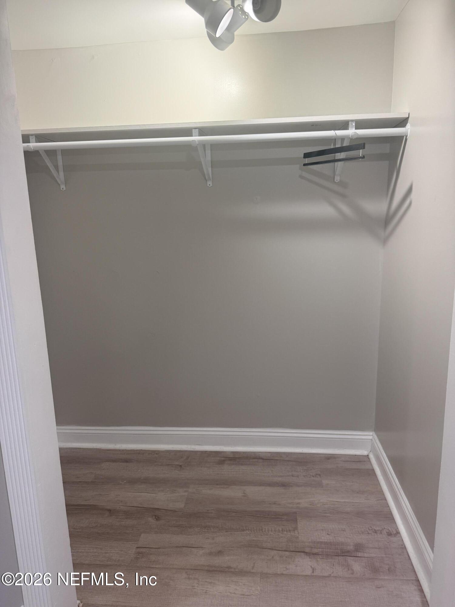 200 Walnut Street, Unit 1 Neptune Beach, FL 32266 - Photo 10 of 12 a view of a closet with wooden floor