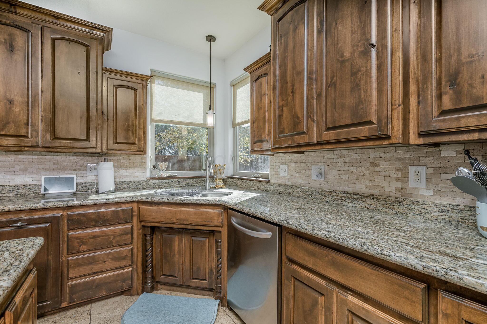 101 Pheasant Run Canyon, TX 79015 - Photo 12 of 39 a kitchen with stainless steel appliances granite countertop a sink stove and cabinets
