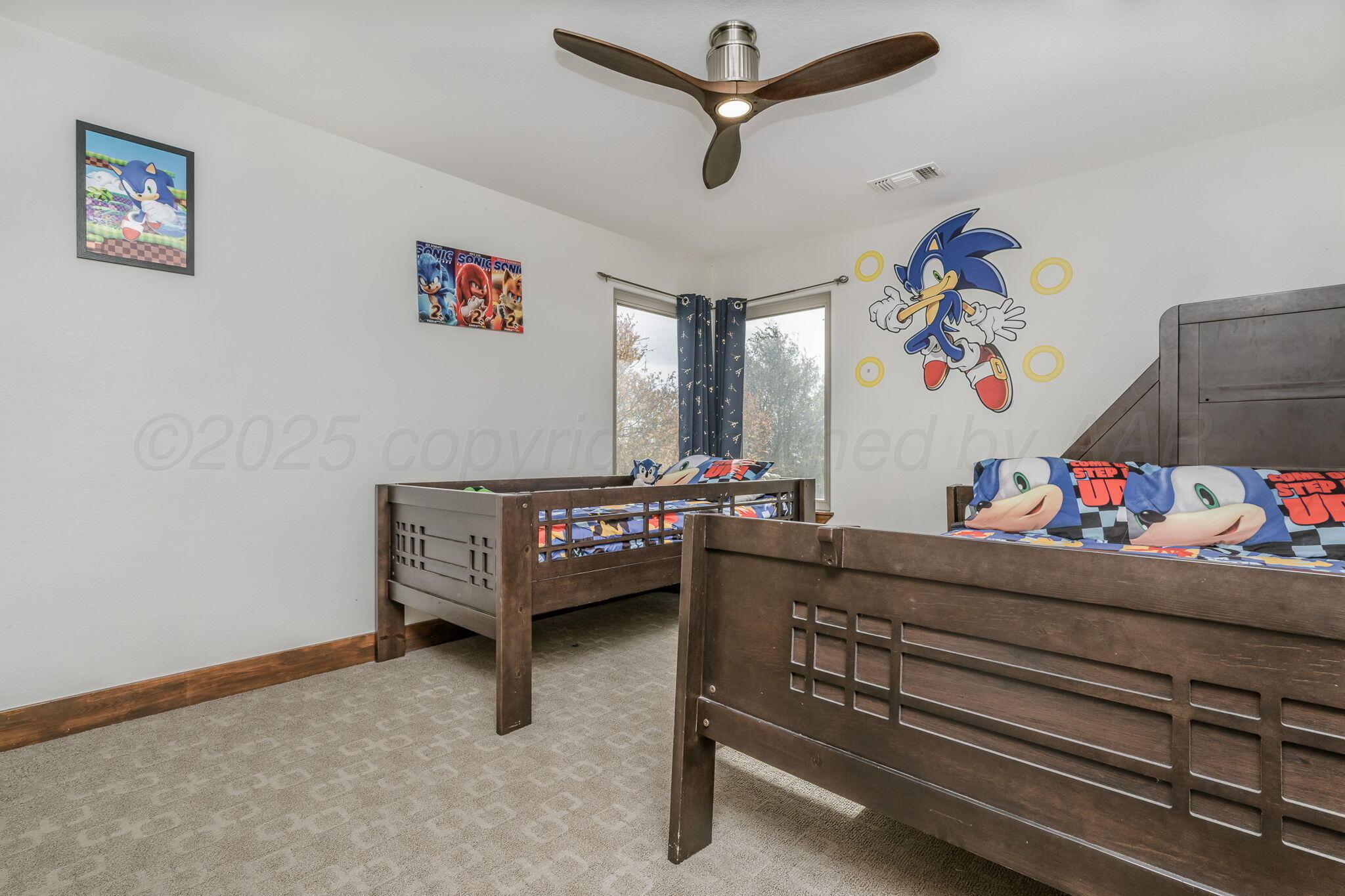 101 Pheasant Run Canyon, TX 79015 - Photo 20 of 39 a living room with furniture and a baby crib