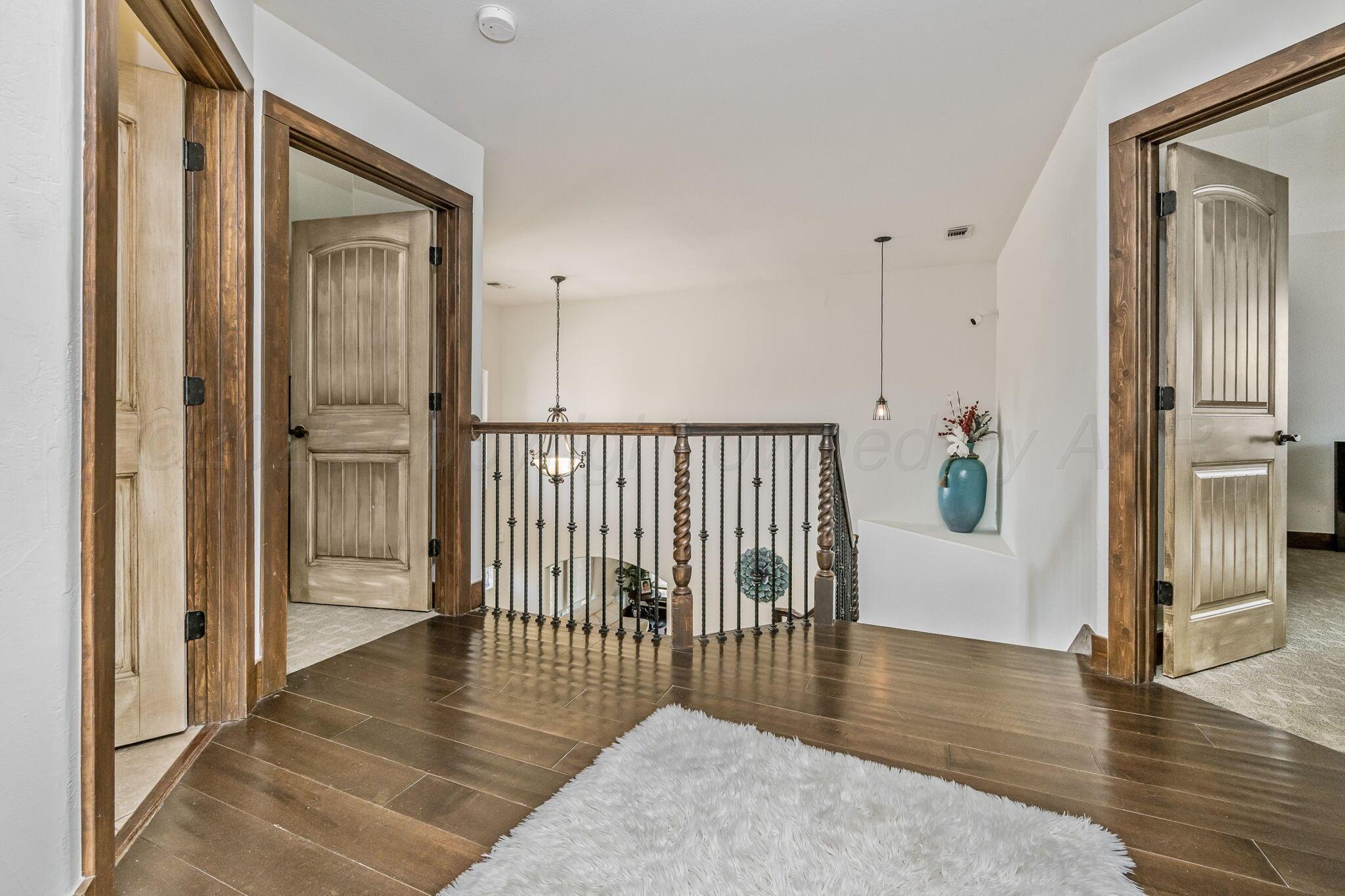 101 Pheasant Run Canyon, TX 79015 - Photo 21 of 39 a view of a hallway with wooden floor and dining room