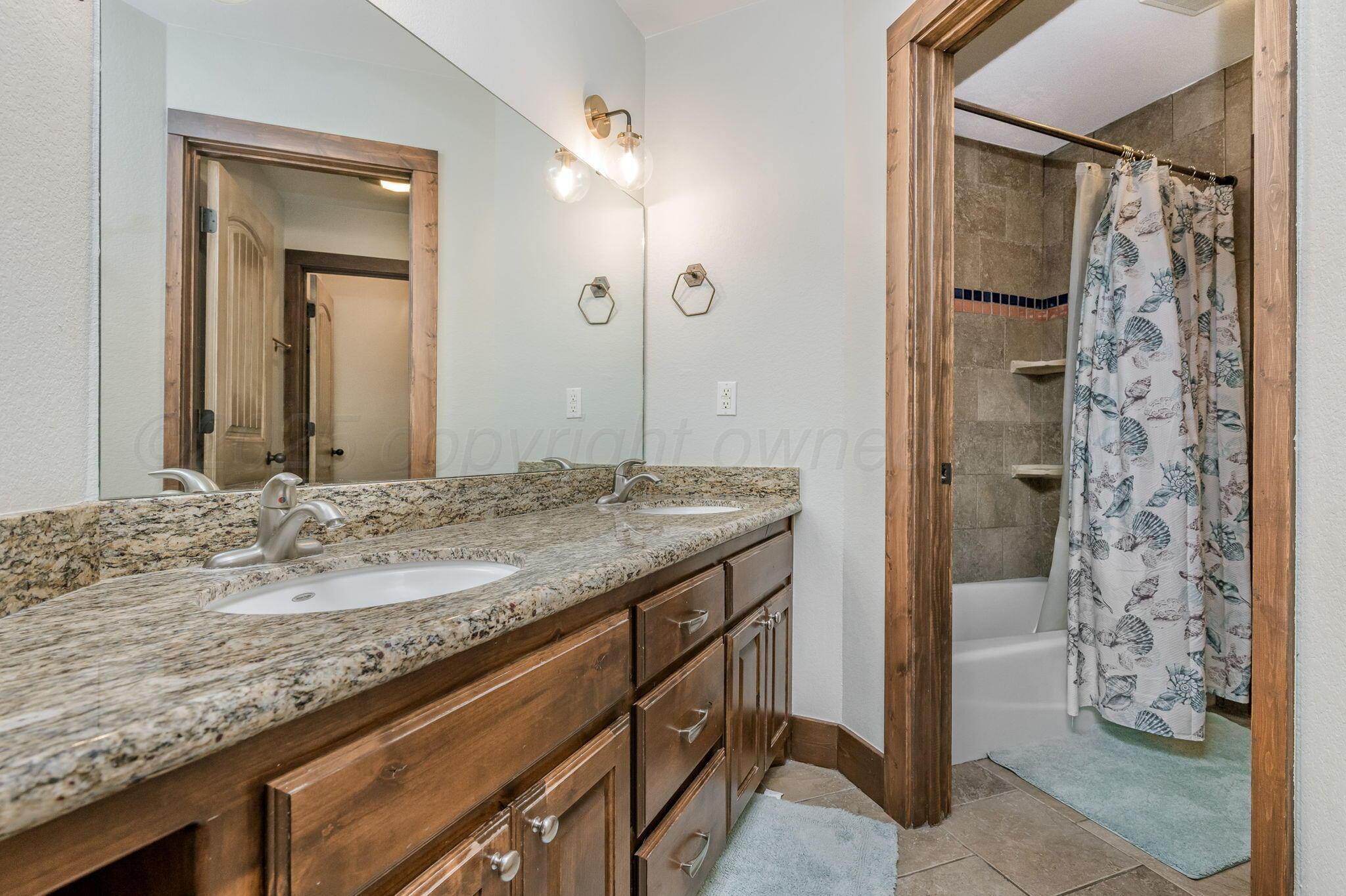 101 Pheasant Run Canyon, TX 79015 - Photo 23 of 39 a bathroom with a granite countertop sink and a mirror