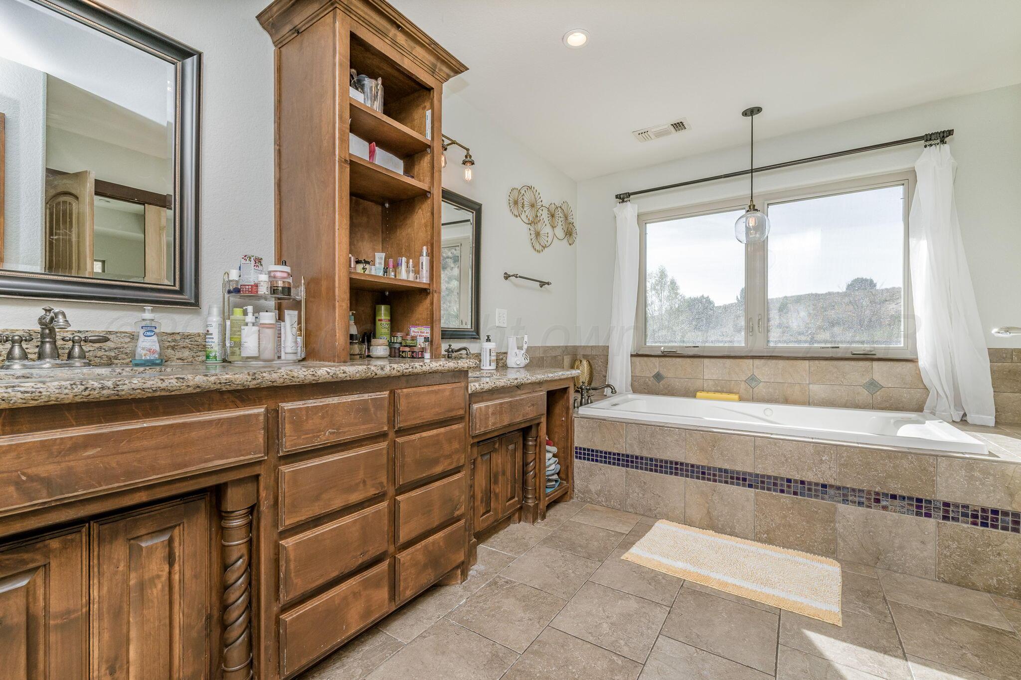 101 Pheasant Run Canyon, TX 79015 - Photo 27 of 39 a bathroom with a tub sink and mirror