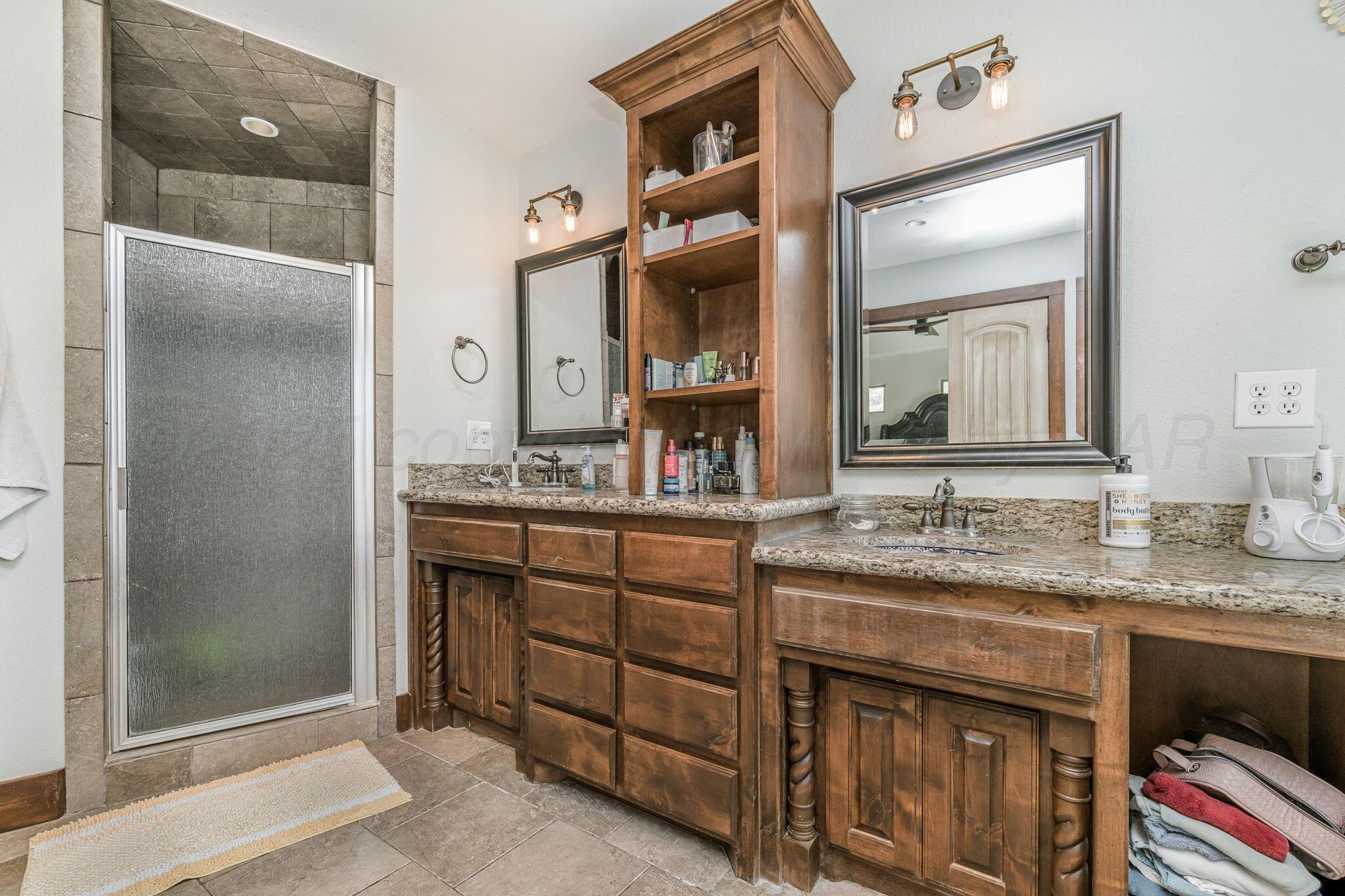 101 Pheasant Run Canyon, TX 79015 - Photo 28 of 39 a bathroom with a granite countertop sink vanity and mirror