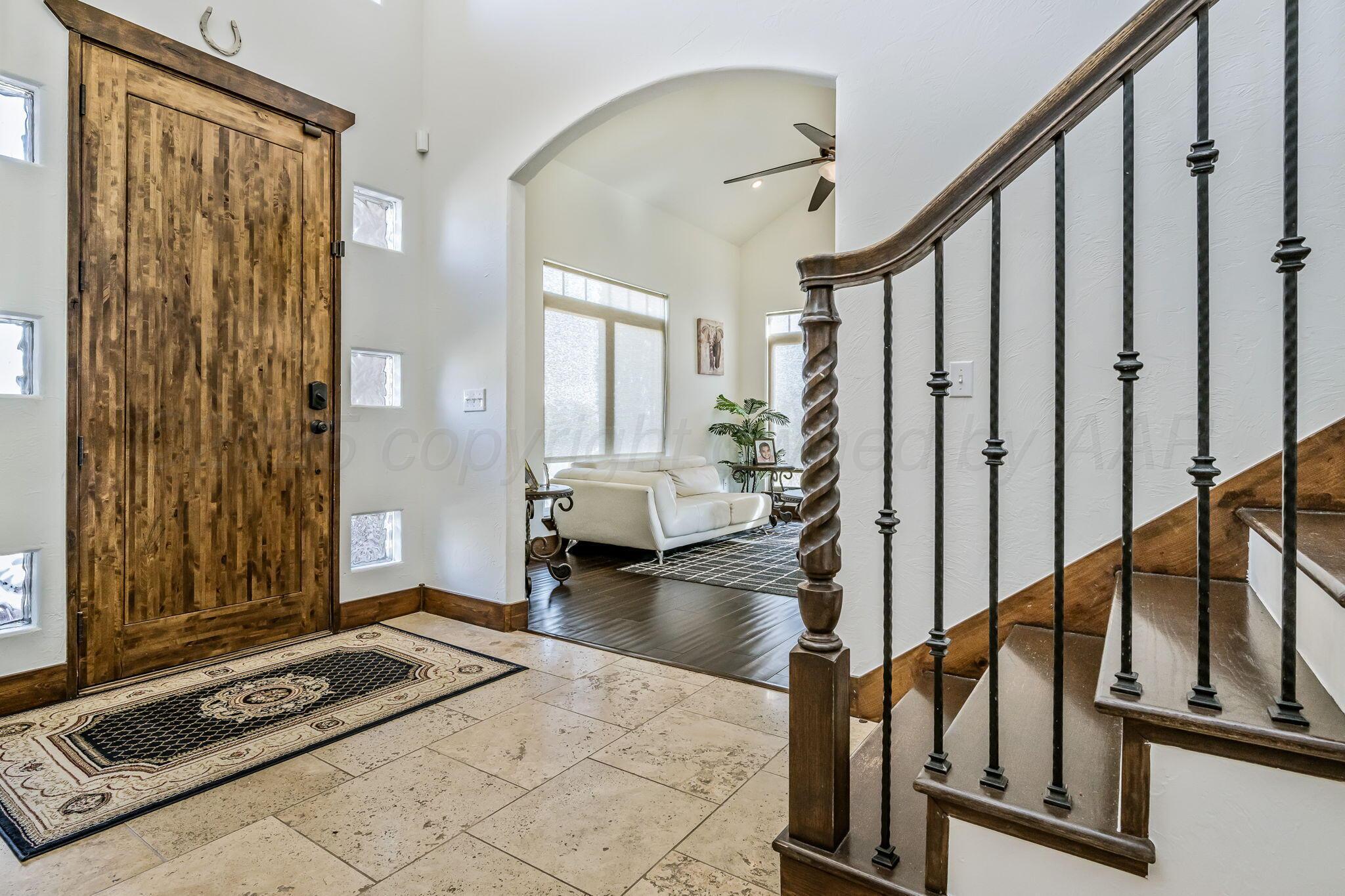 101 Pheasant Run Canyon, TX 79015 - Photo 6 of 39 a view of a hallway with wooden floor and staircase
