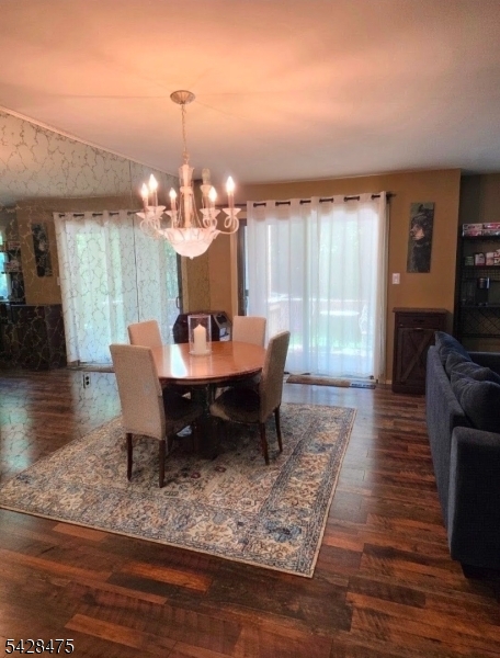 1030 Robin Road Hillsborough, NJ 08844 - Photo 4 of 22 a dining room with wooden floor a chandelier a wooden table and chairs