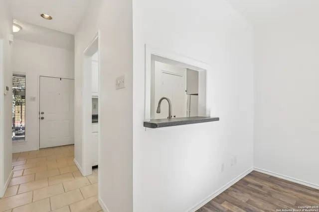 a kitchen with stainless steel appliances granite countertop a sink and refrigerator