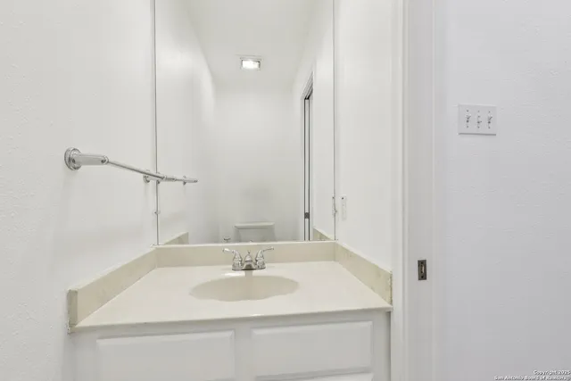 a bathroom with a granite countertop sink a mirror and a bathtub