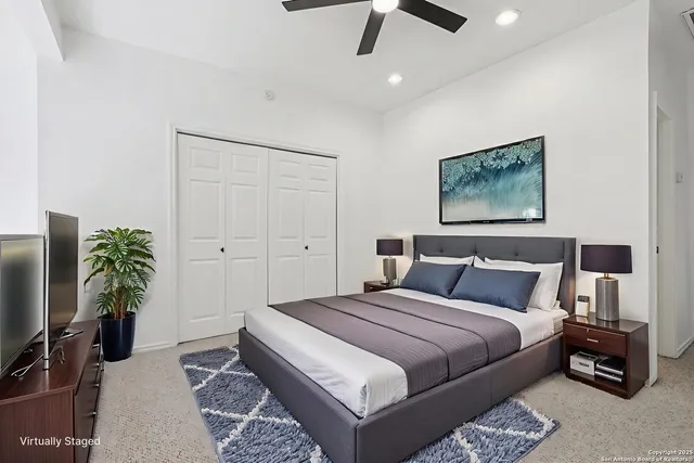 a bedroom with a large bed and a chandelier