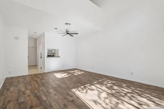 a front view of a house with trees and plants