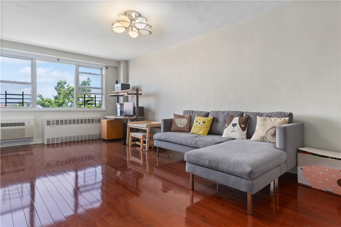 110-50 71st Road, Unit 9B Queens, NY 11375 - Photo 1 of 1 a living room with furniture and a window