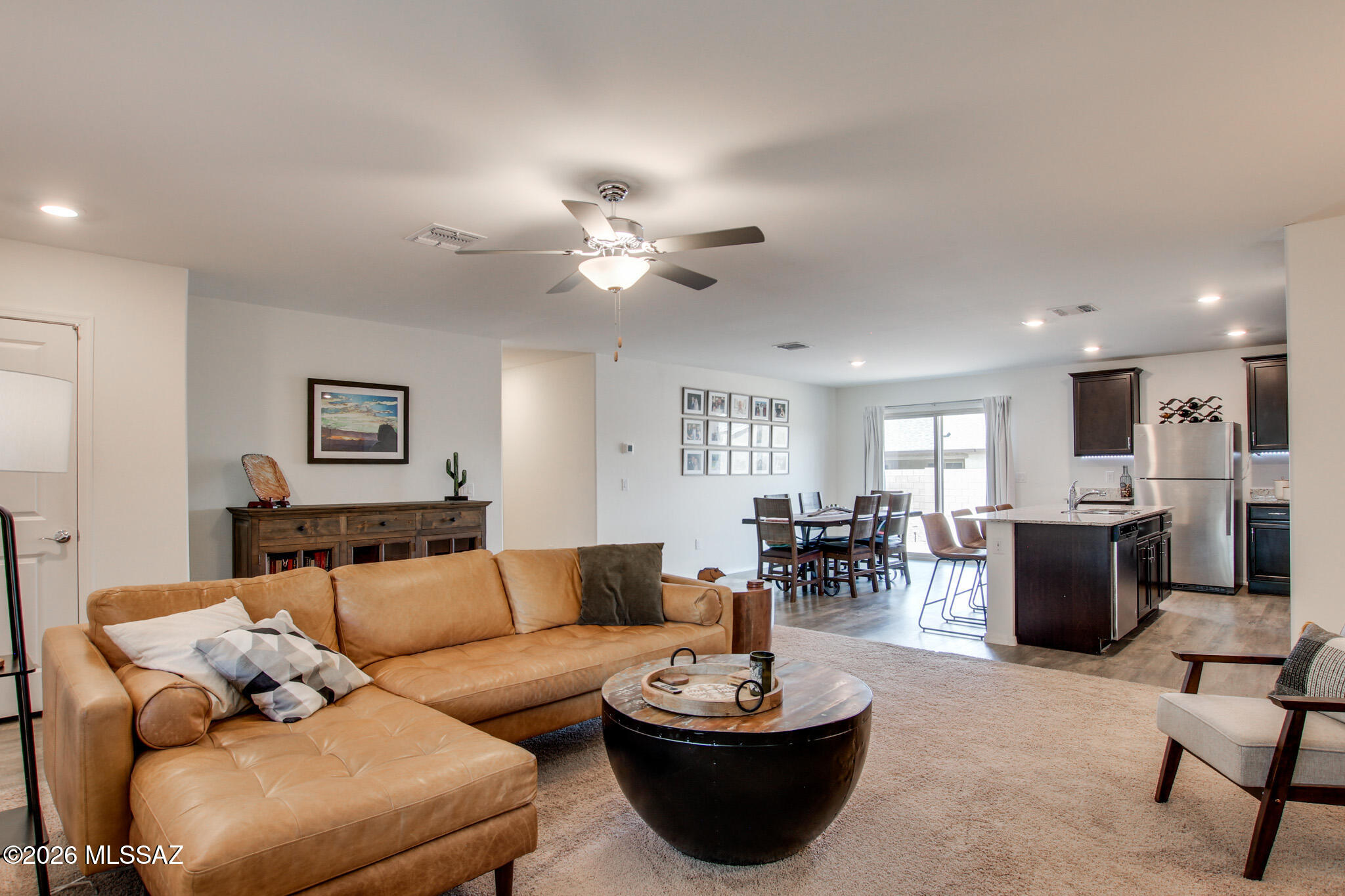 7056 South Draper Road Tucson, AZ 85757 - Photo 6 of 22 a living room with furniture kitchen view and a potted plant