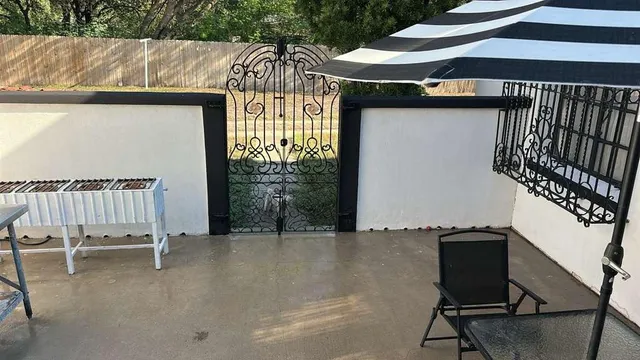 a view of an chairs and table in the balcony