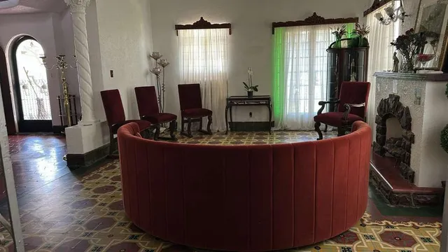 a room with furniture mirror and window