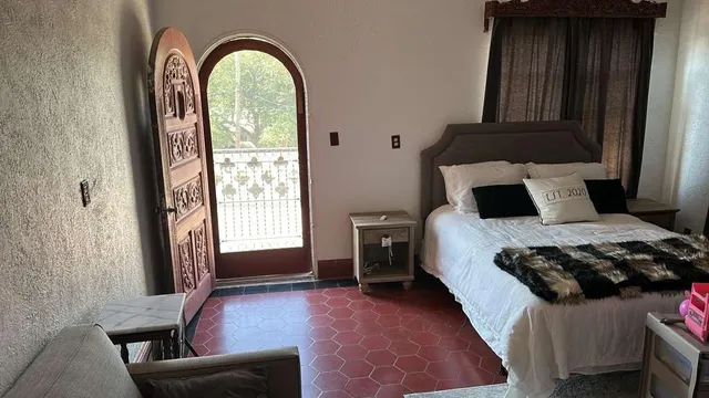 a bedroom with furniture and a window