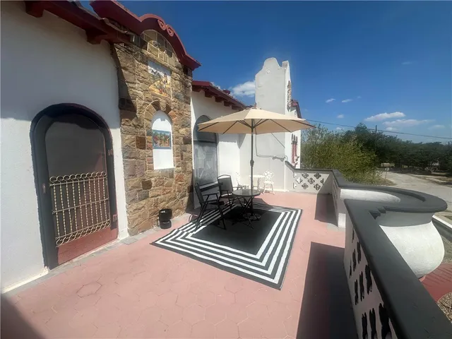 a view of a patio with a table and chairs