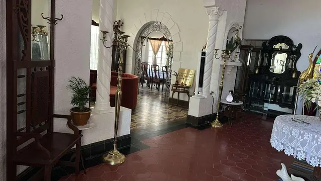 a living room with furniture and a mirror
