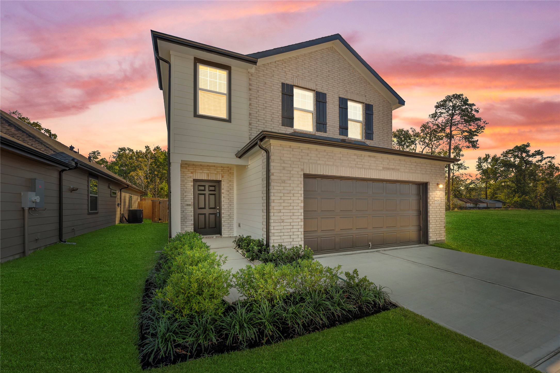 18829 Lucas Michael Way New Caney, TX 77357 - Photo 1 of 40 a front view of a house with garden
