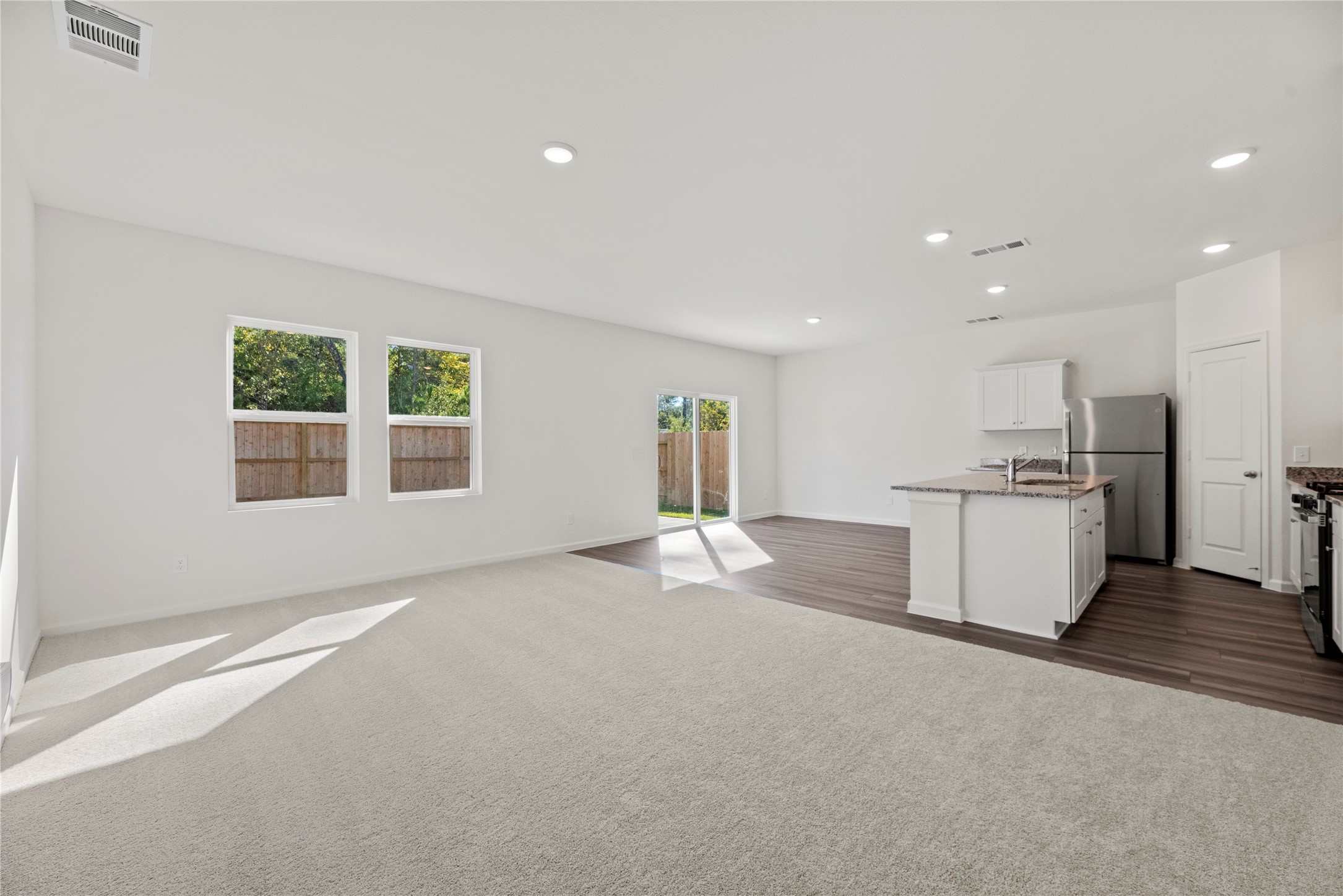 18829 Lucas Michael Way New Caney, TX 77357 - Photo 13 of 40 a view of a kitchen with a sink and dishwasher a kitchen island with wooden floor