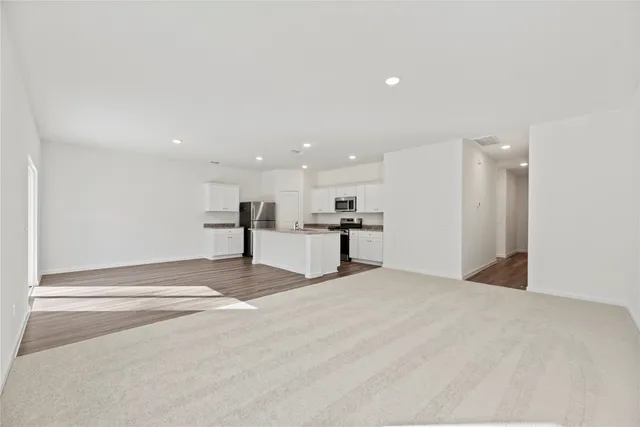 a view of kitchen with a refrigerator and a window