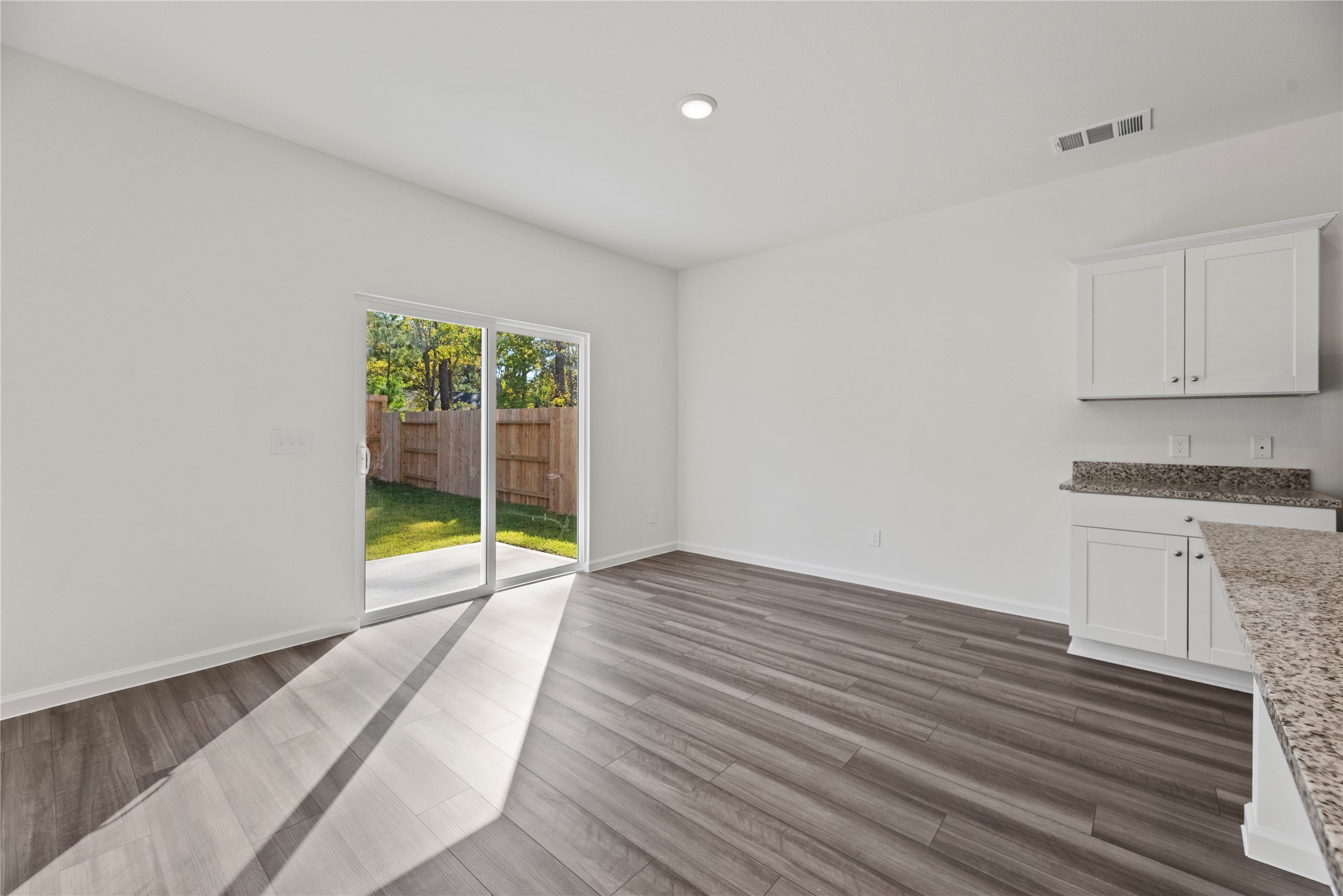 18829 Lucas Michael Way New Caney, TX 77357 - Photo 18 of 40 a view of an empty room with a window and wooden floor