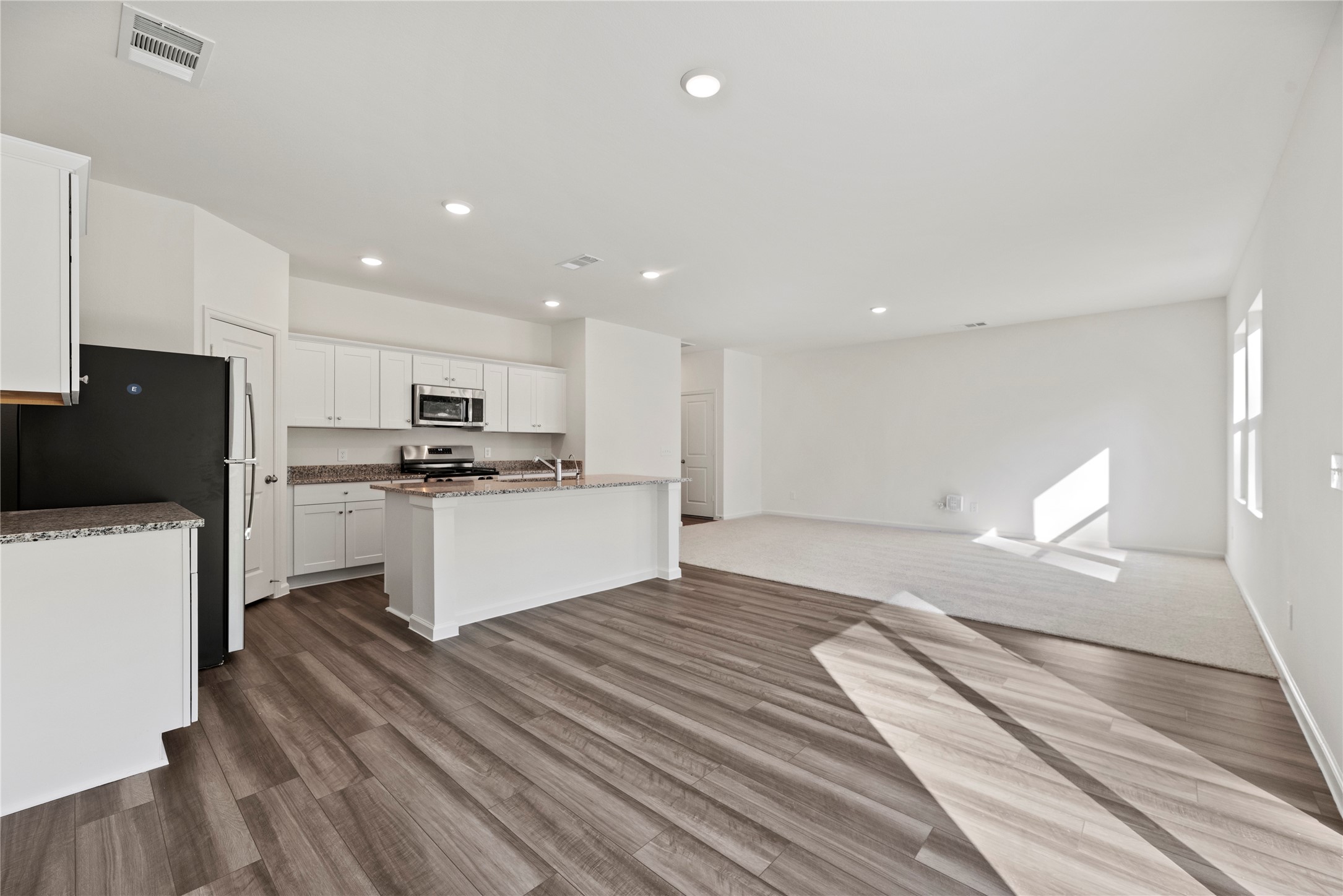 18829 Lucas Michael Way New Caney, TX 77357 - Photo 19 of 40 a kitchen with a refrigerator and a stove top oven