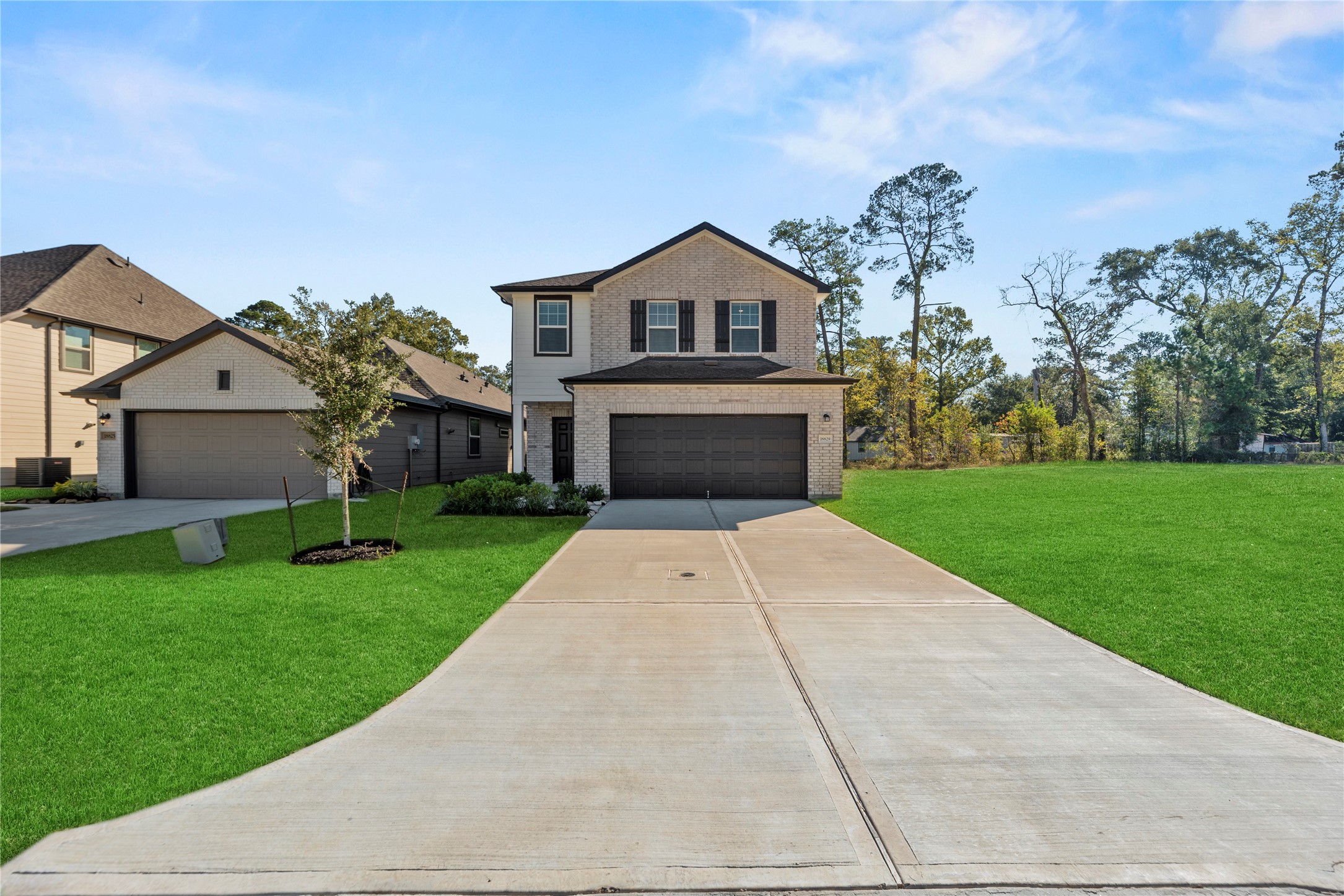 18829 Lucas Michael Way New Caney, TX 77357 - Photo 2 of 40 a front view of a house with a yard and garage