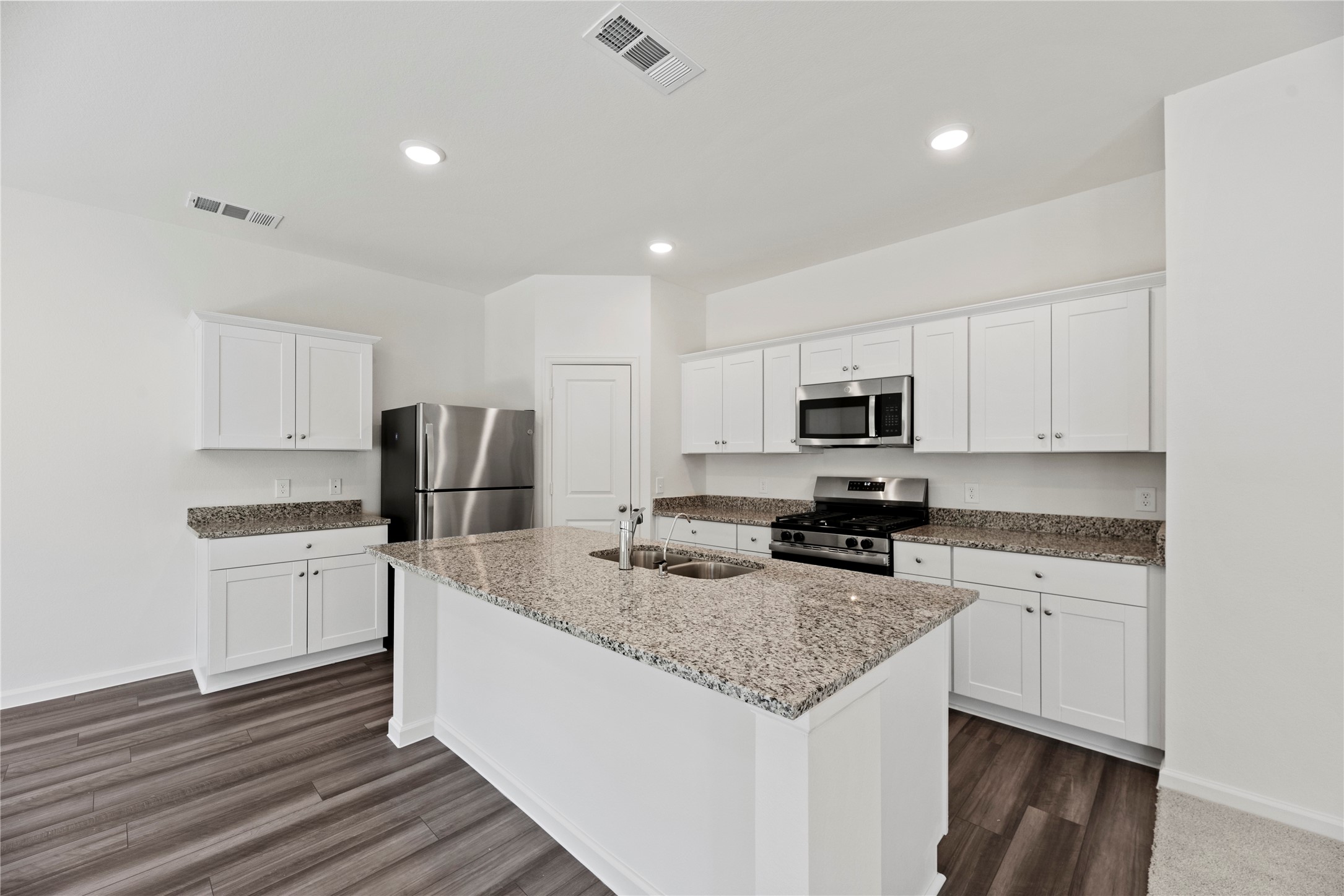 18829 Lucas Michael Way New Caney, TX 77357 - Photo 22 of 40 a kitchen with stainless steel appliances granite countertop a sink stove and refrigerator