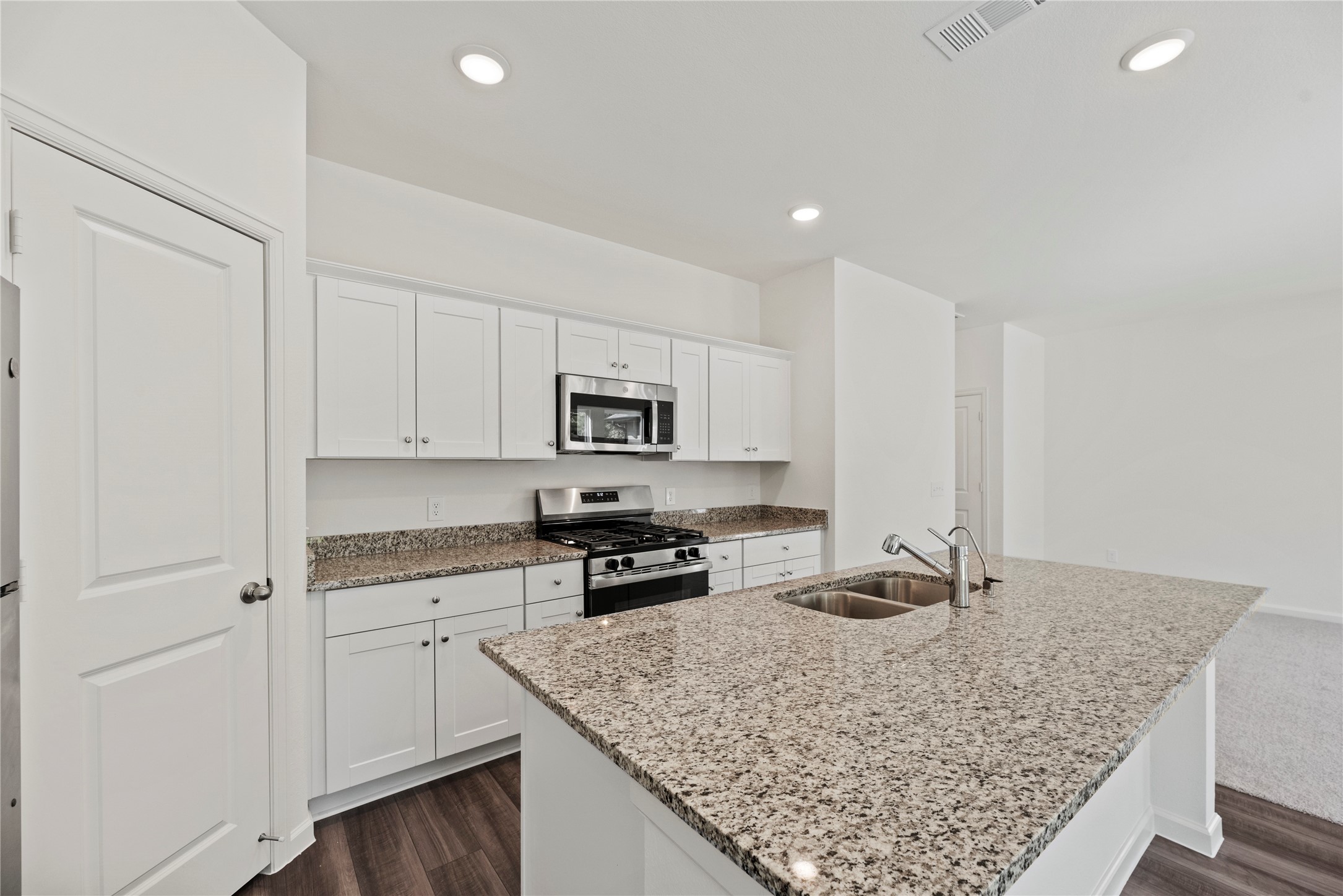 18829 Lucas Michael Way New Caney, TX 77357 - Photo 23 of 40 a kitchen with stainless steel appliances granite countertop a sink stove and cabinets