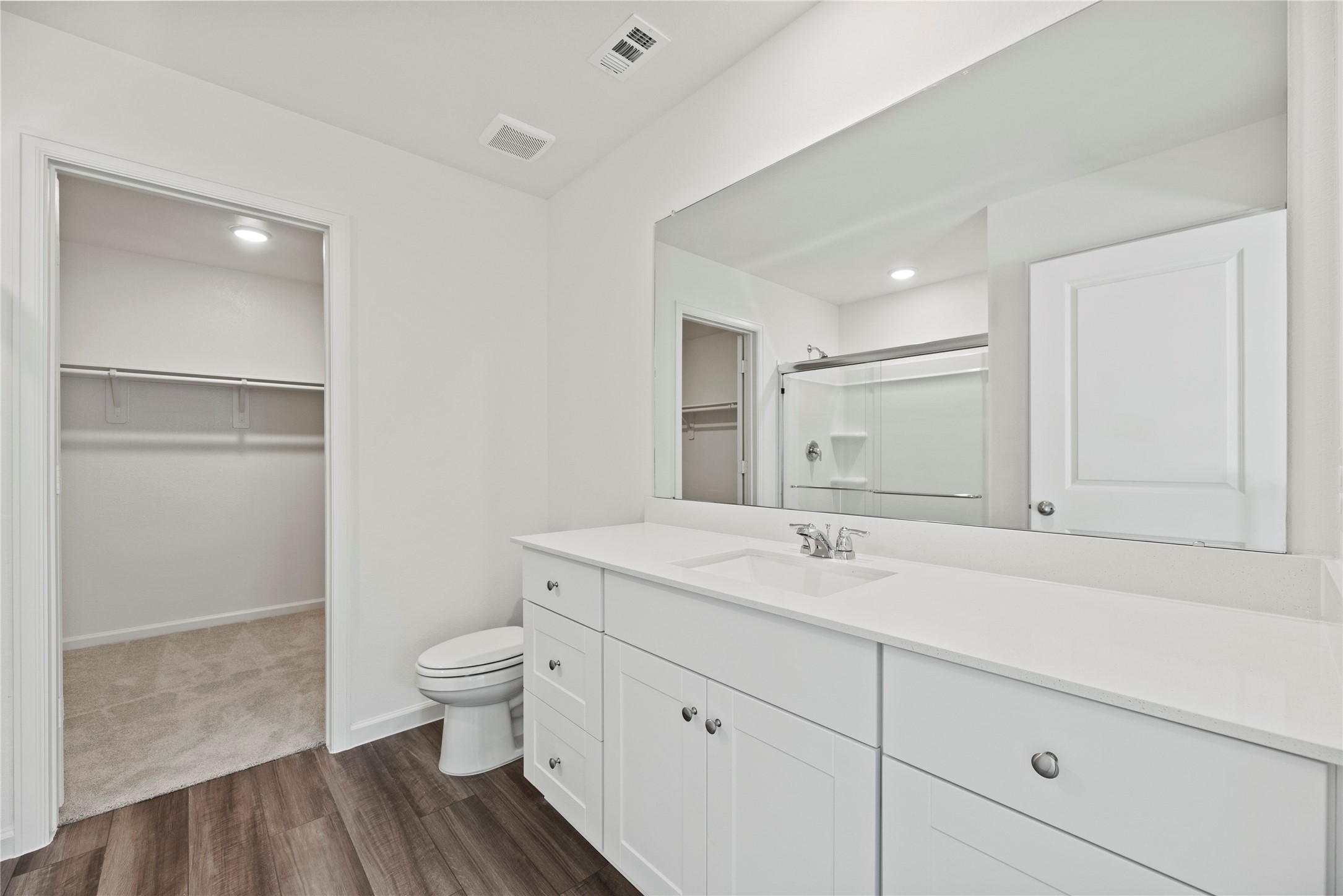 18829 Lucas Michael Way New Caney, TX 77357 - Photo 30 of 40 a bathroom with a sink a toilet and a large mirror