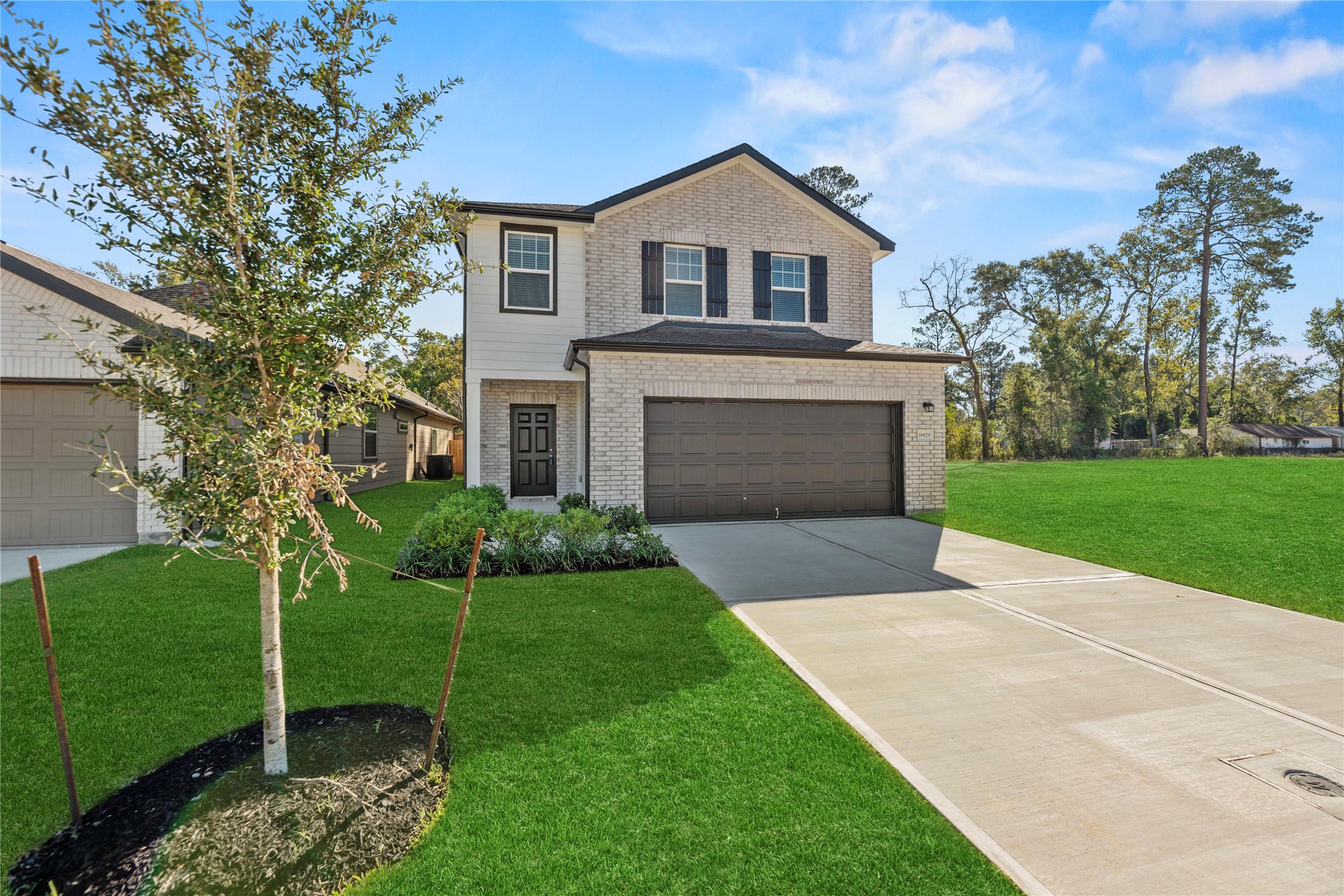 18829 Lucas Michael Way New Caney, TX 77357 - Photo 3 of 40 a front view of a house with a yard and garage