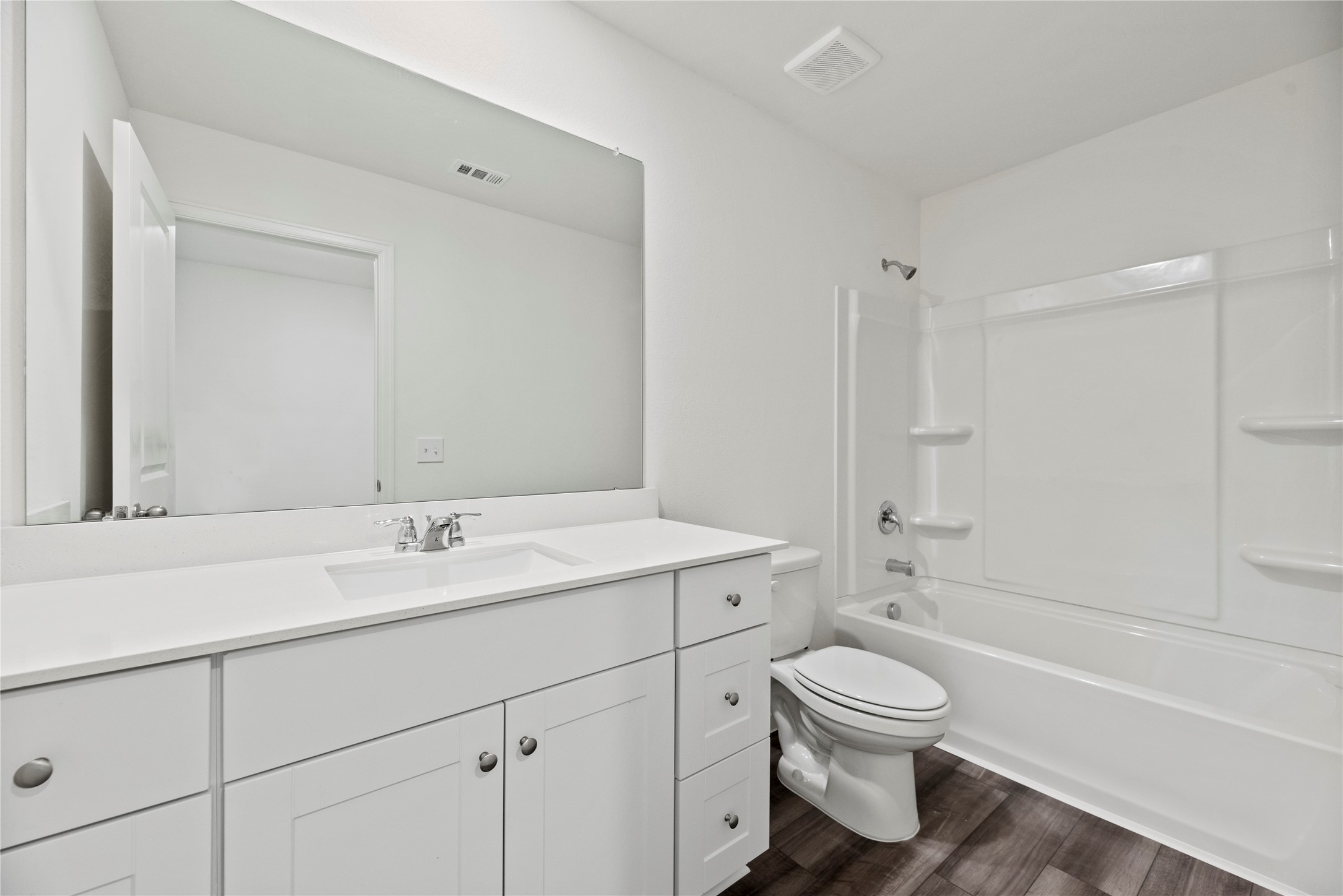 18829 Lucas Michael Way New Caney, TX 77357 - Photo 35 of 40 a bathroom with a toilet sink a mirror and shower