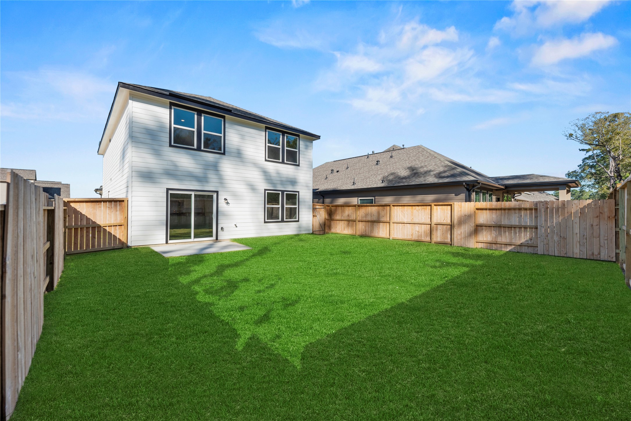 18829 Lucas Michael Way New Caney, TX 77357 - Photo 9 of 40 a backyard of a house with lots of green space and garden